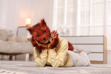 Photo of Quadrobics. Woman wearing fox mask and gloves at home