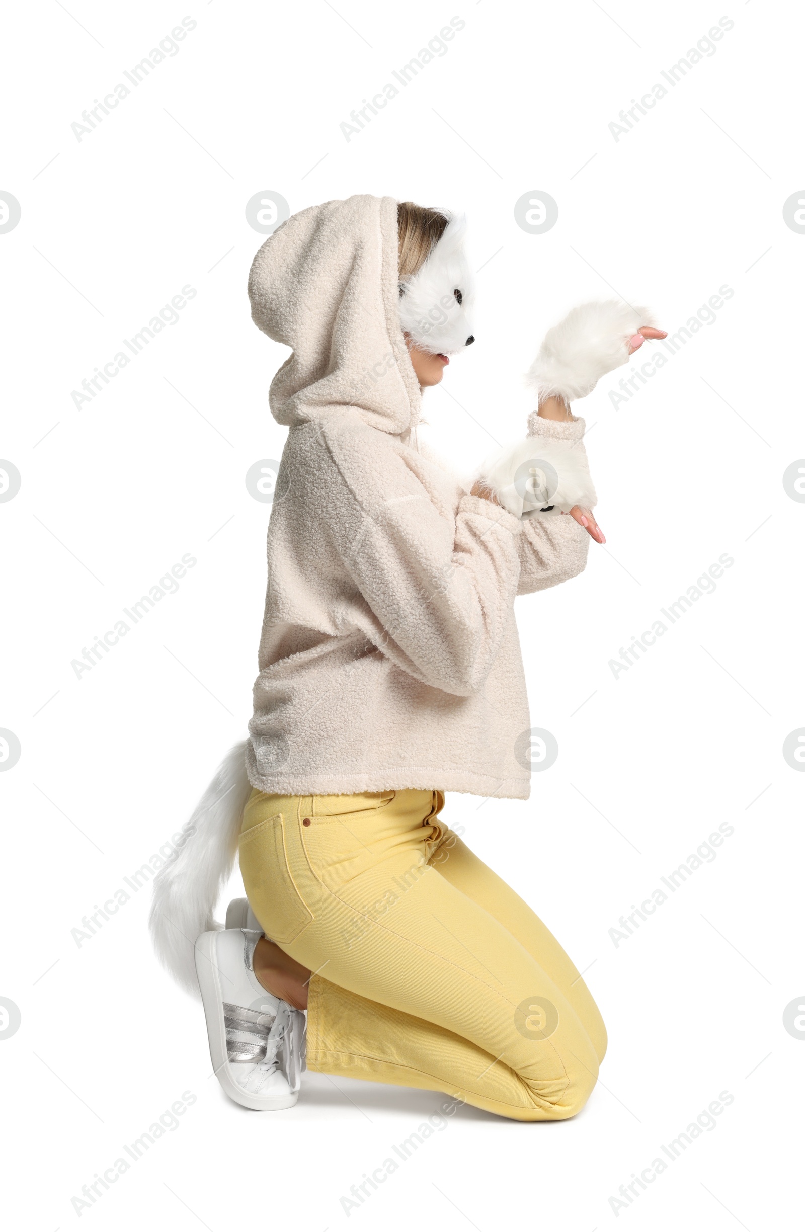 Photo of Quadrobics. Woman wearing cat mask, gloves and tail on white background