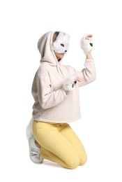 Photo of Quadrobics. Woman wearing cat mask, gloves and tail on white background