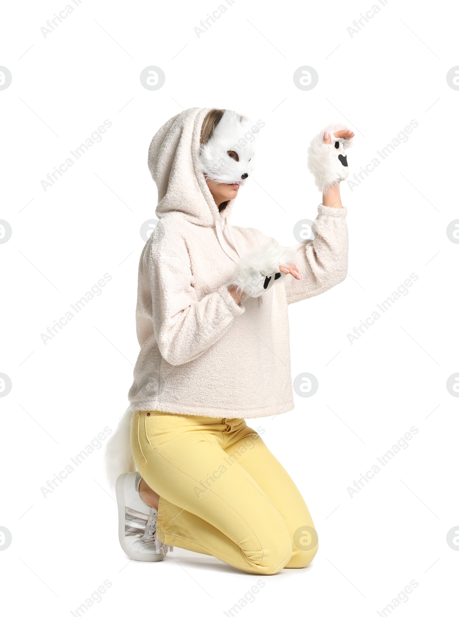 Photo of Quadrobics. Woman wearing cat mask, gloves and tail on white background