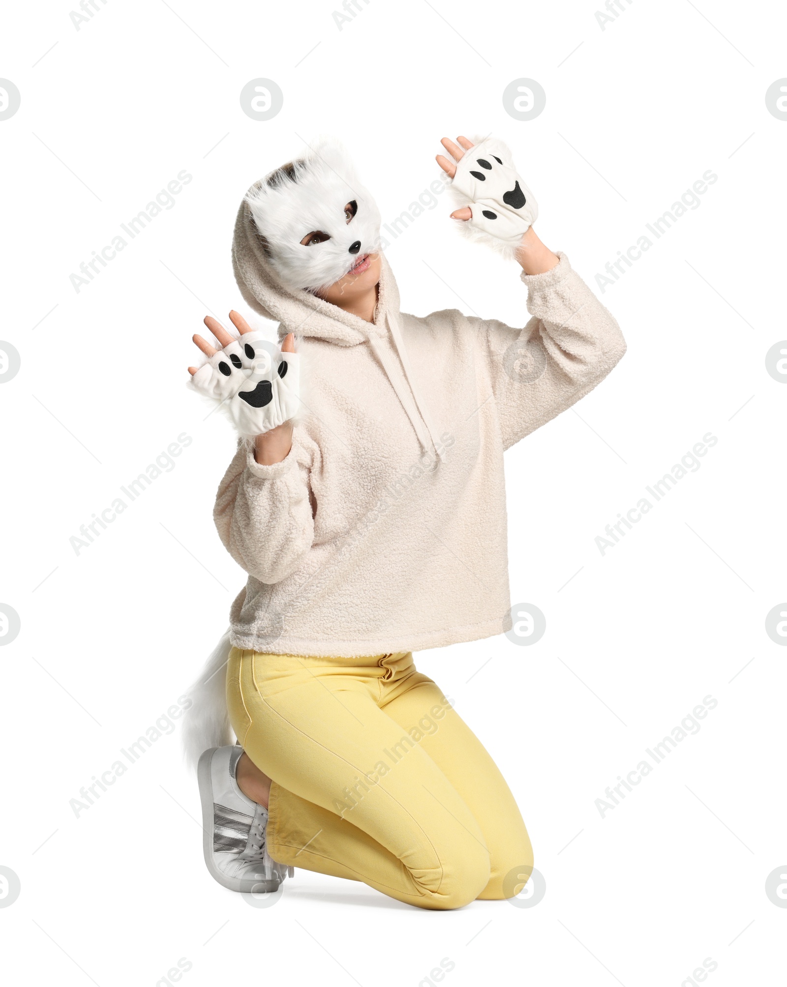 Photo of Quadrobics. Woman wearing cat mask, gloves and tail on white background