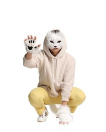 Photo of Quadrobics. Woman wearing cat mask, gloves and tail on white background