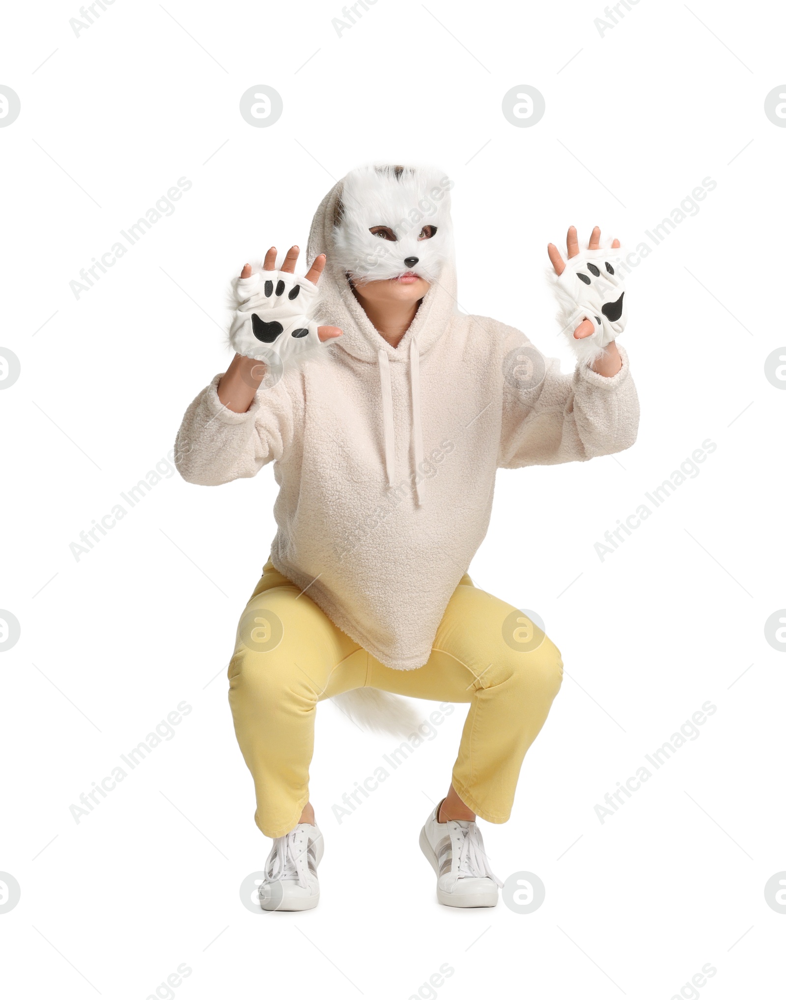 Photo of Quadrobics. Woman wearing cat mask, gloves and tail on white background