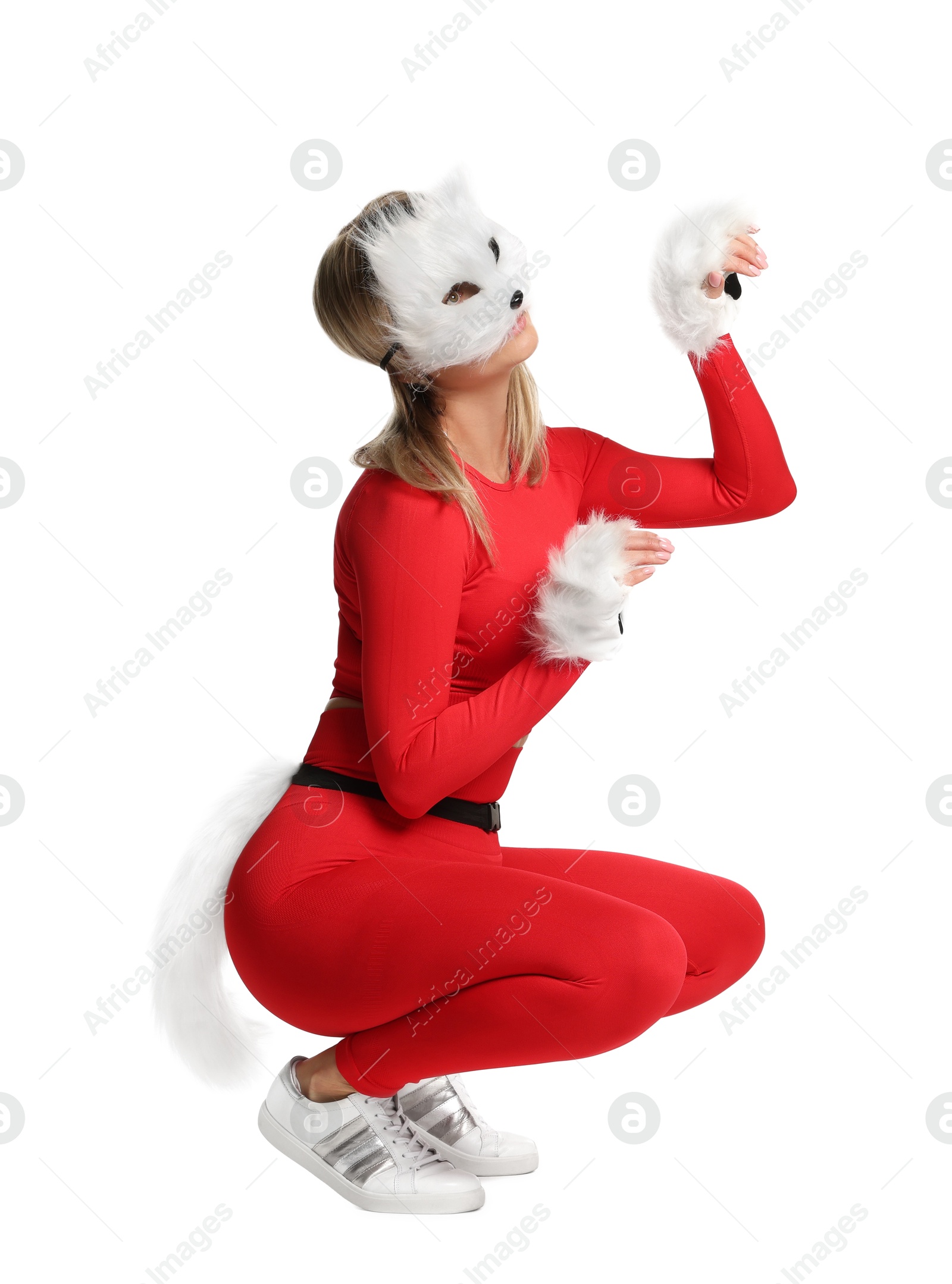 Photo of Quadrobics. Woman wearing cat mask, gloves and tail on white background