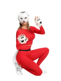 Photo of Quadrobics. Woman wearing cat mask, gloves and tail on white background