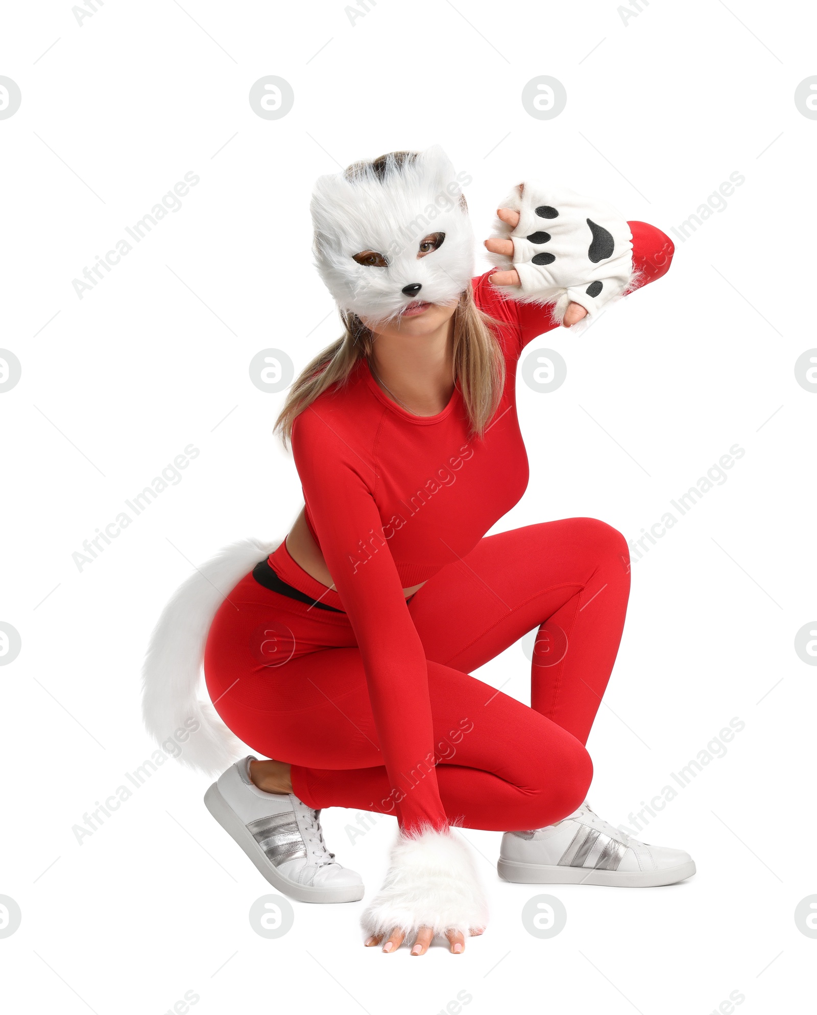 Photo of Quadrobics. Woman wearing cat mask, gloves and tail on white background