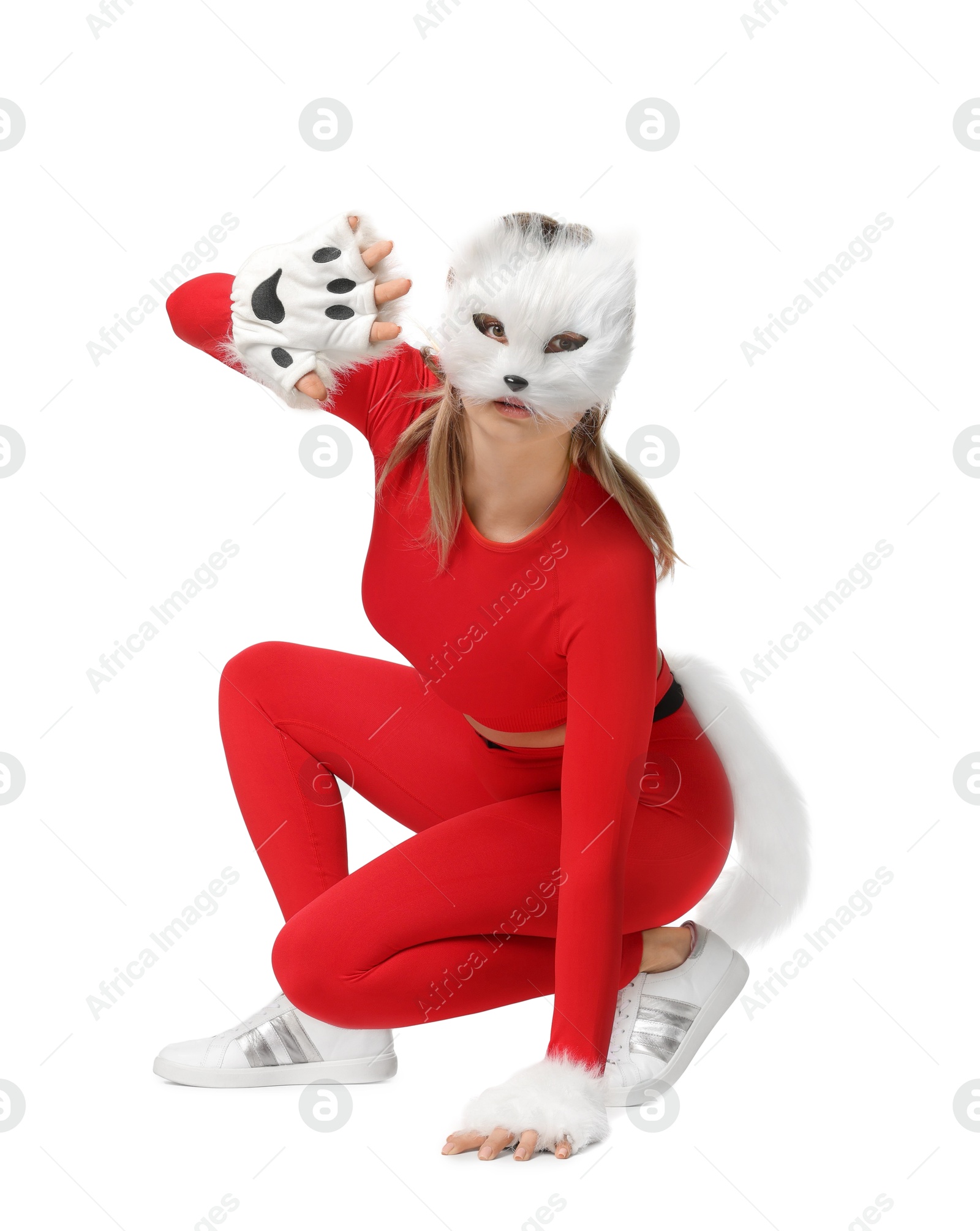 Photo of Quadrobics. Woman wearing cat mask, gloves and tail on white background