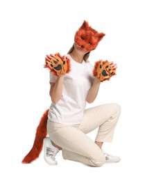 Photo of Quadrobics. Woman wearing fox mask, gloves and tail on white background