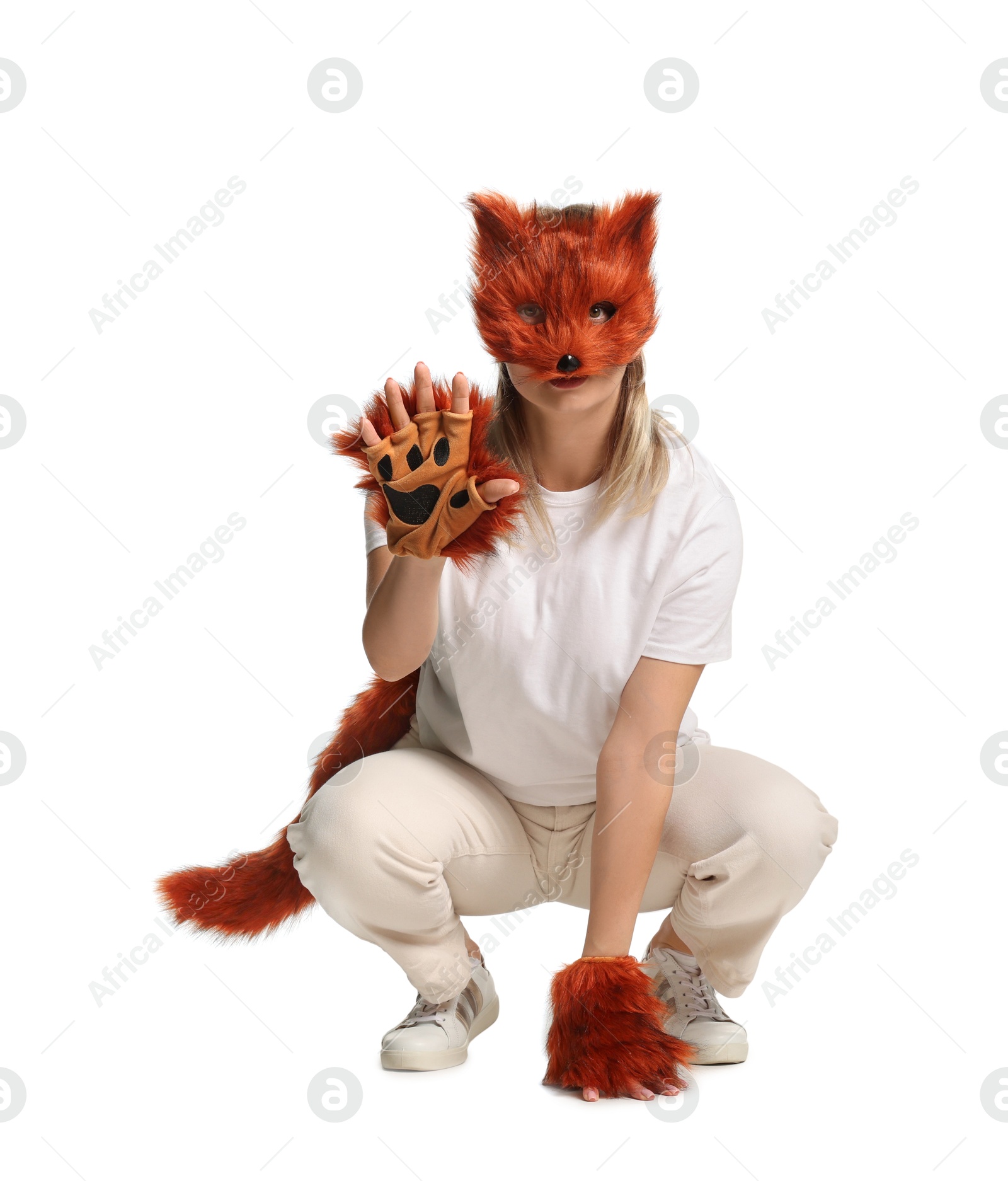 Photo of Quadrobics. Woman wearing fox mask, gloves and tail on white background