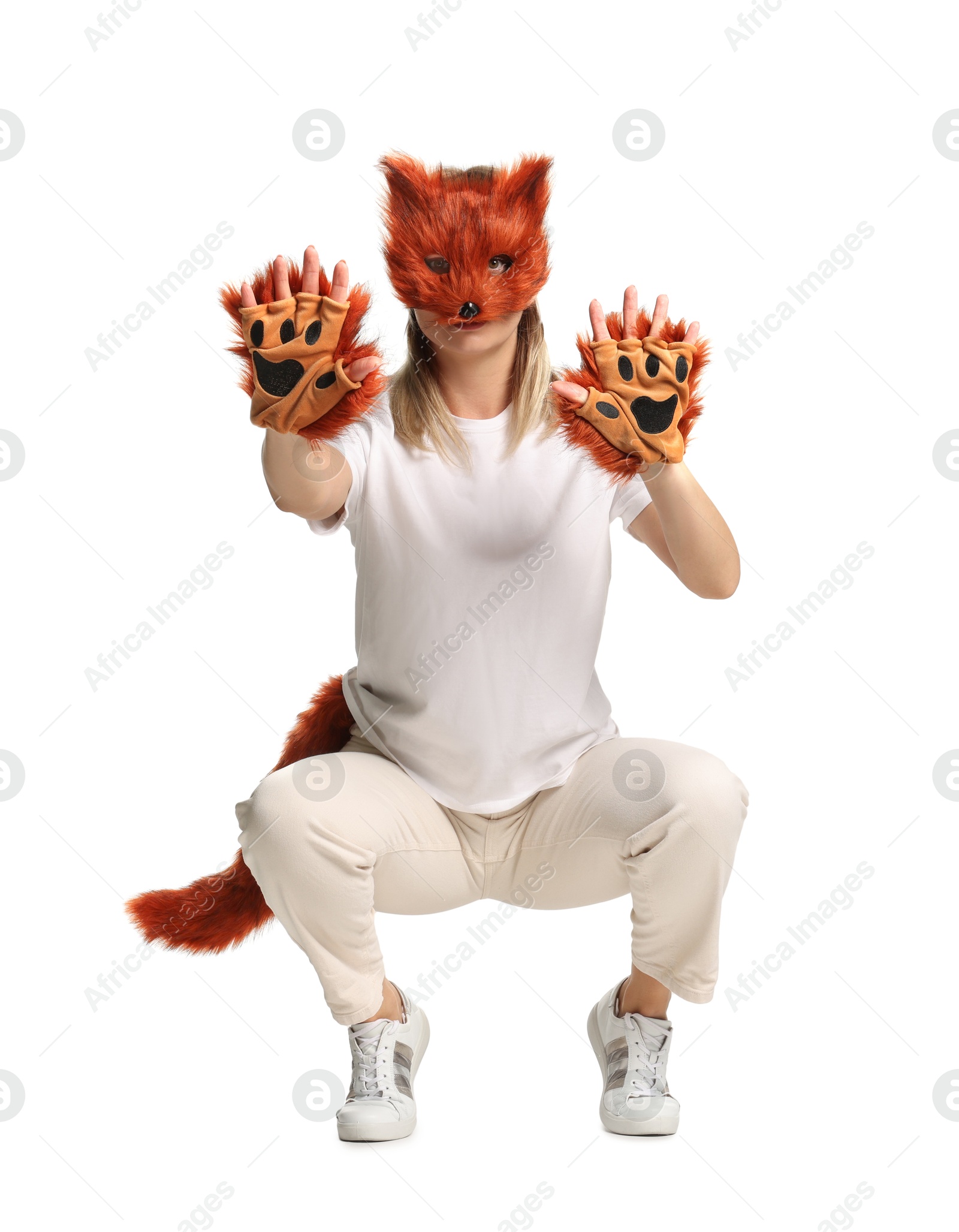 Photo of Quadrobics. Woman wearing fox mask, gloves and tail on white background