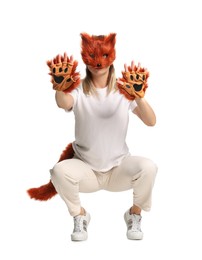 Photo of Quadrobics. Woman wearing fox mask, gloves and tail on white background