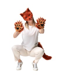 Photo of Quadrobics. Woman wearing fox mask, gloves and tail on white background