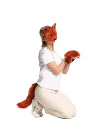 Photo of Quadrobics. Woman wearing fox mask, gloves and tail on white background