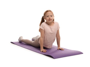 Photo of Cute little girl on fitness mat against white background