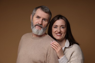 Photo of Family portrait of happy daughter and her father on brown background