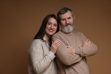 Photo of Family portrait of happy daughter and her father on brown background