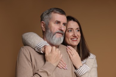 Photo of Family portrait of happy daughter and her father on brown background