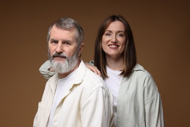 Photo of Family portrait of happy daughter and her father on brown background