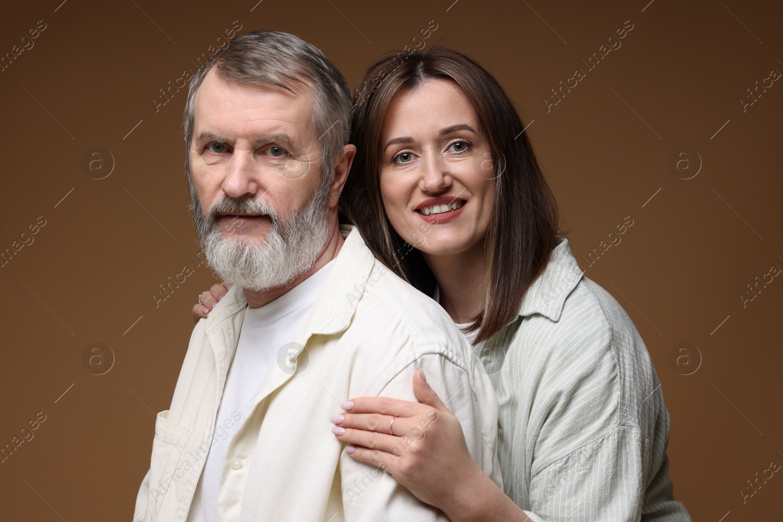 Photo of Family portrait of happy daughter and her father on brown background