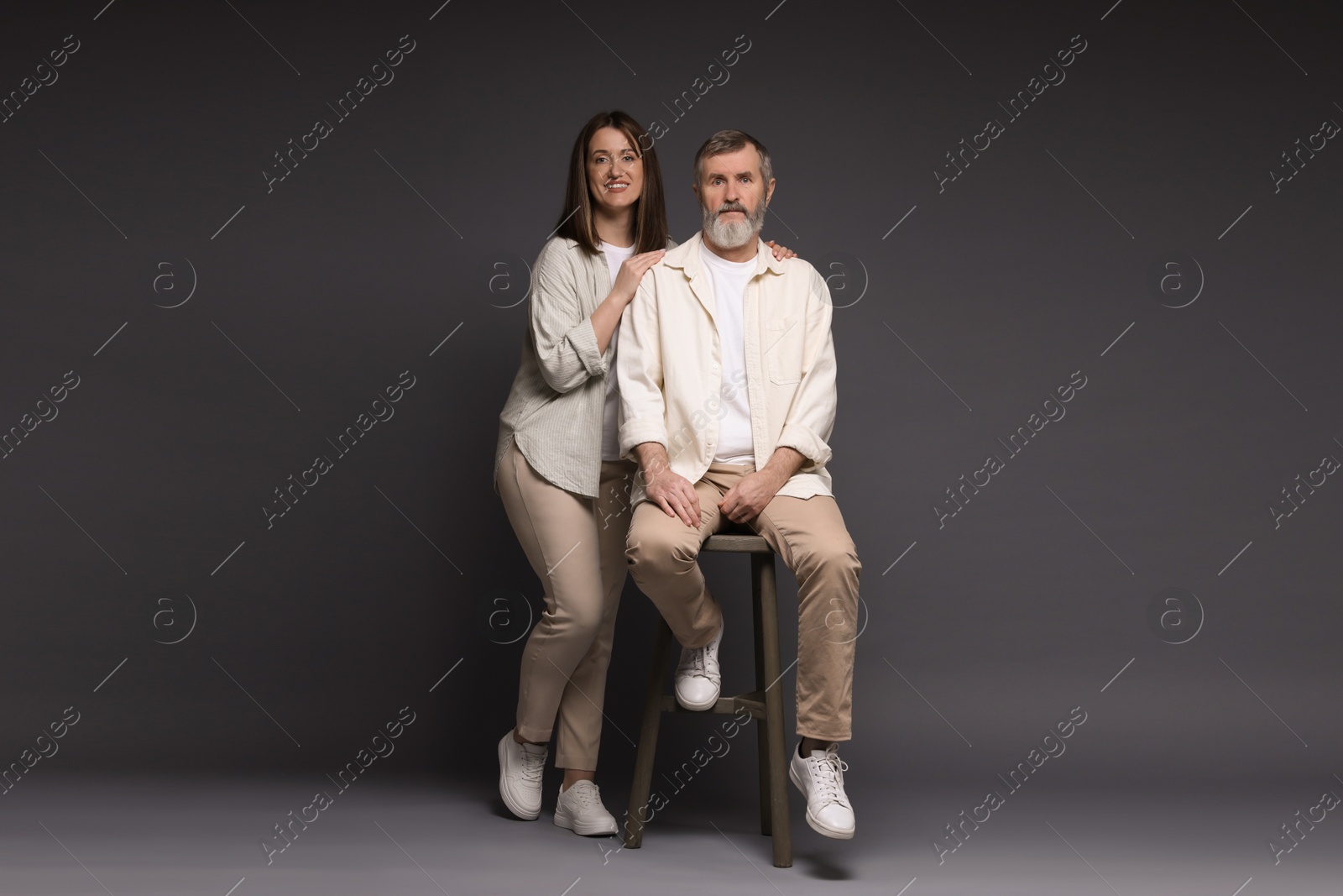 Photo of Happy daughter and her father on dark background