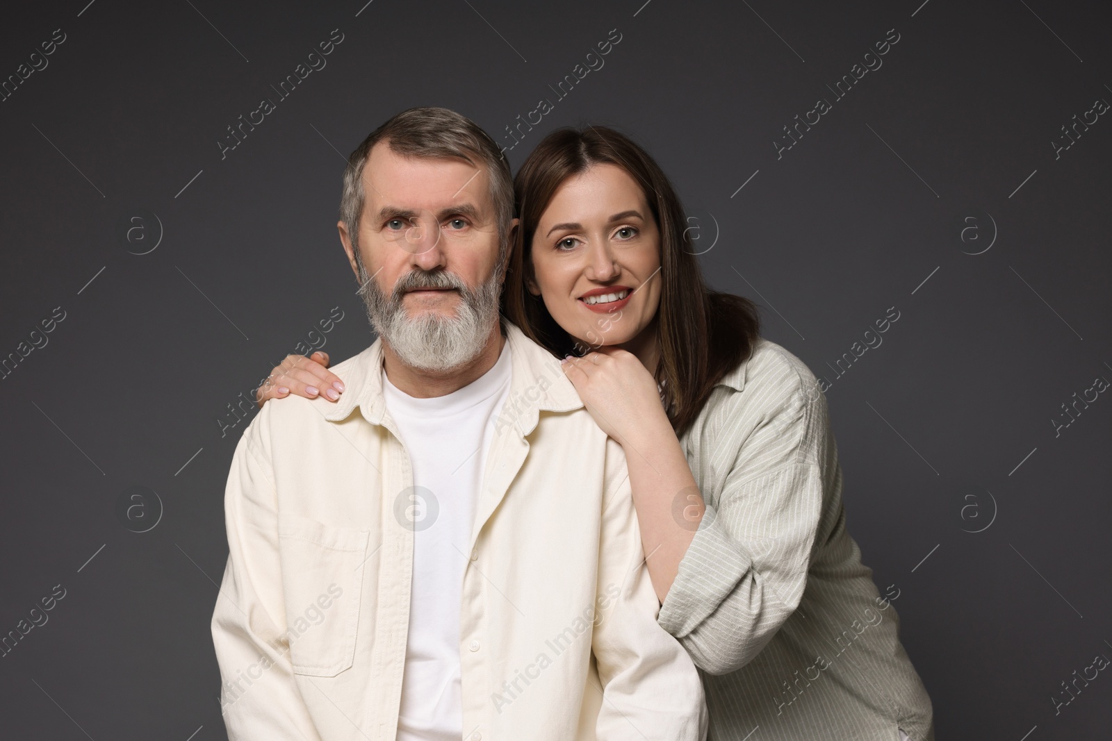 Photo of Family portrait of happy daughter and her father on dark background