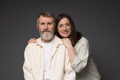 Photo of Family portrait of happy daughter and her father on dark background