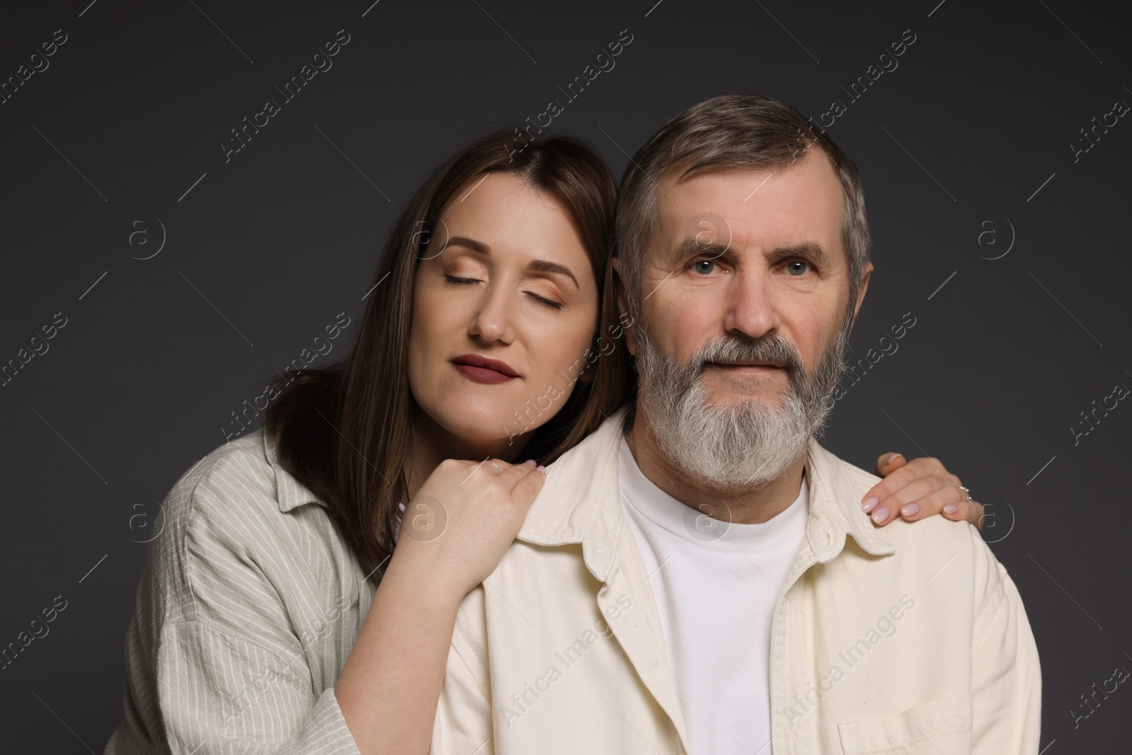 Photo of Family portrait of daughter and her father on dark background