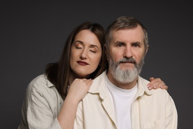 Photo of Family portrait of daughter and her father on dark background