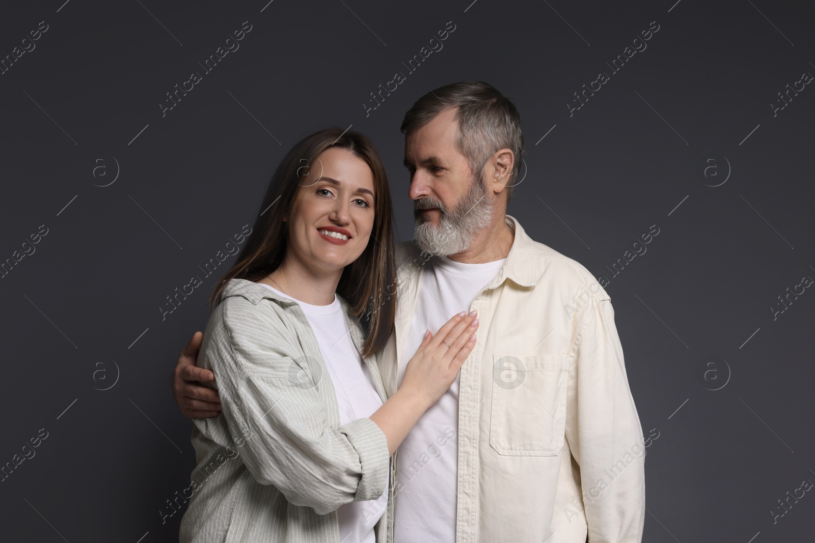 Photo of Family portrait of happy daughter and her father on dark background