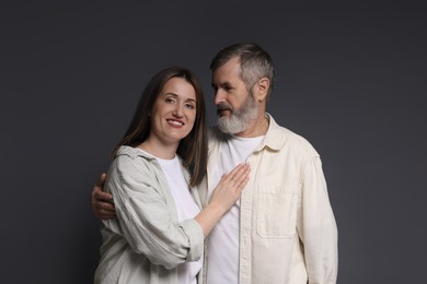 Photo of Family portrait of happy daughter and her father on dark background