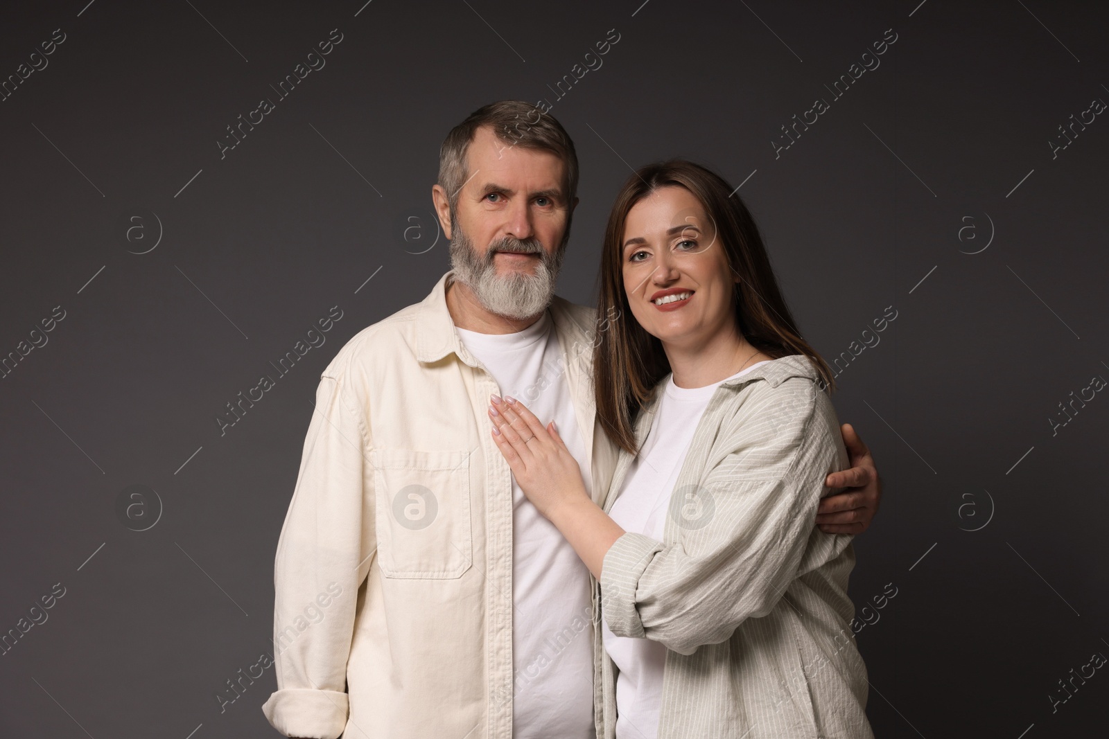 Photo of Family portrait of happy daughter and her father on dark background