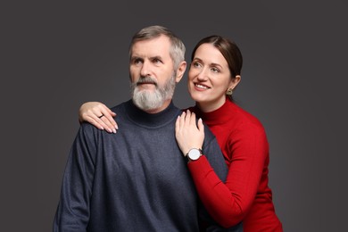 Photo of Happy daughter and her father on dark background