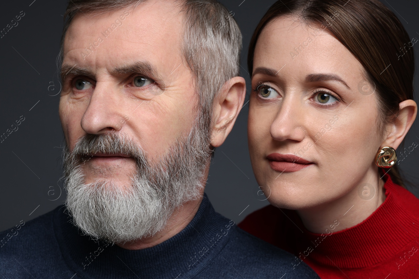 Photo of Daughter and her father on dark background, closeup