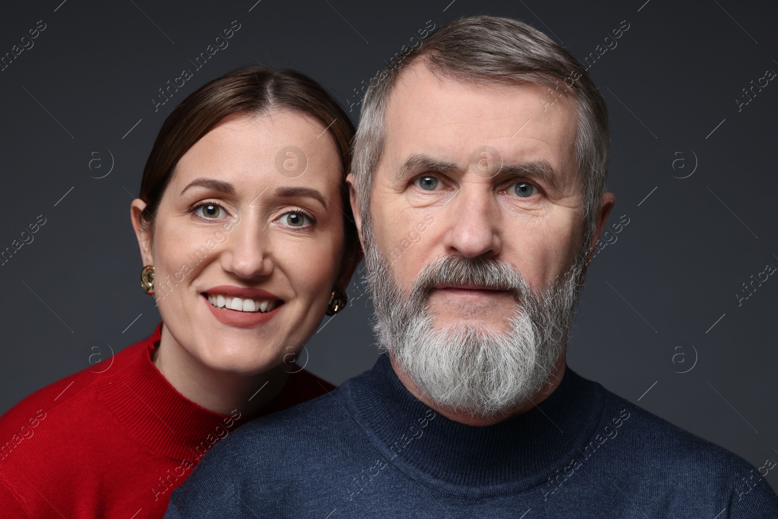 Photo of Family portrait of happy daughter and her father on dark background