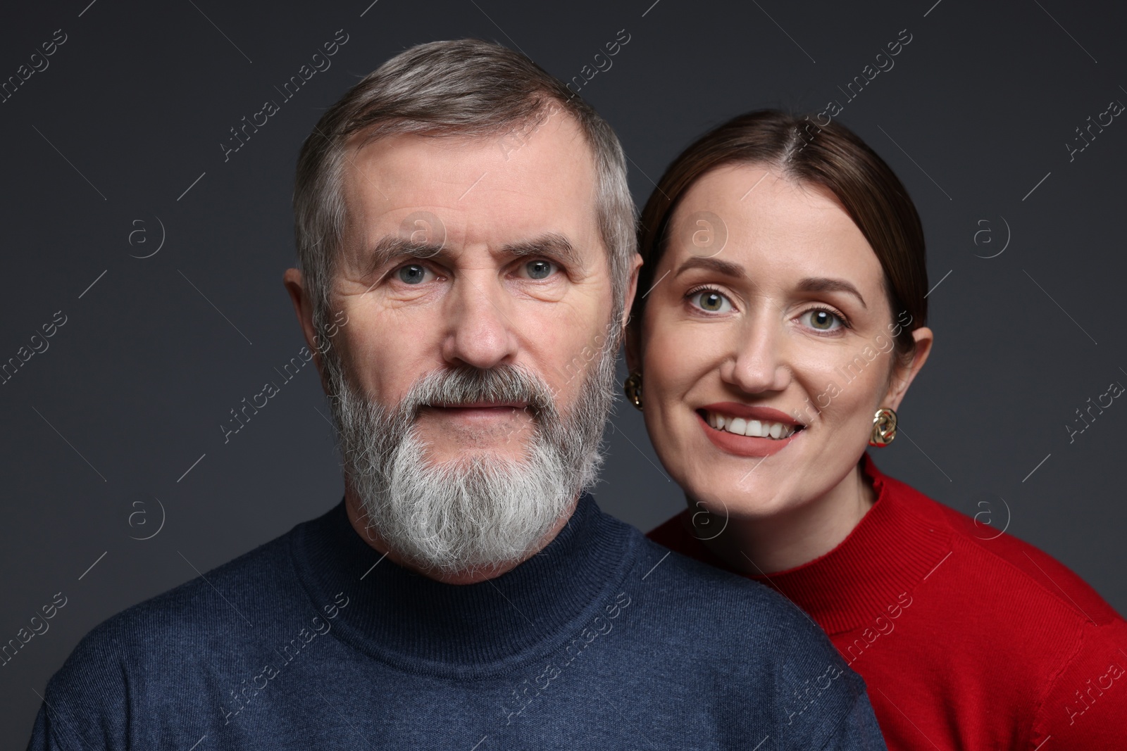 Photo of Family portrait of happy daughter and her father on dark background