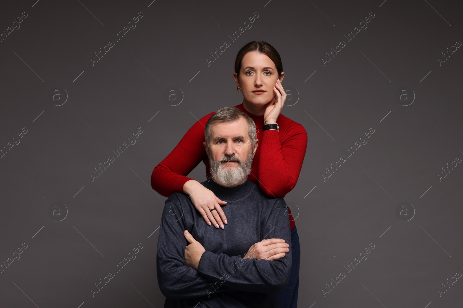 Photo of Family portrait of daughter and her father on dark background