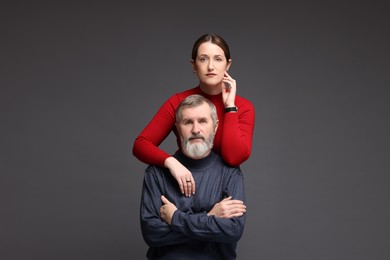 Photo of Family portrait of daughter and her father on dark background