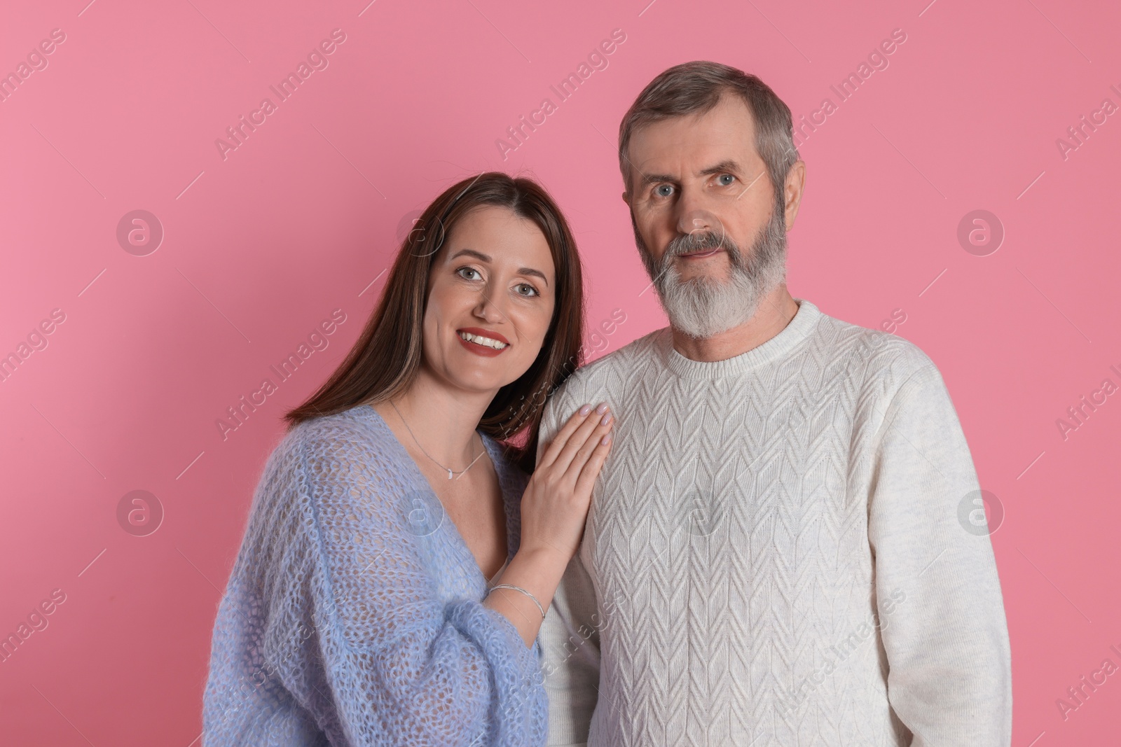 Photo of Family portrait of happy daughter and her father on pink background