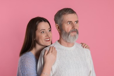 Photo of Happy daughter and her father on pink background