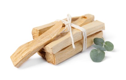 Photo of Palo santo sticks and eucalyptus branch isolated on white