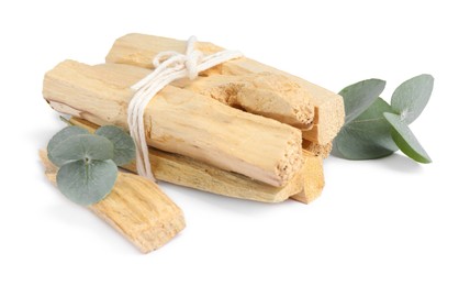 Photo of Palo santo sticks and eucalyptus branches isolated on white