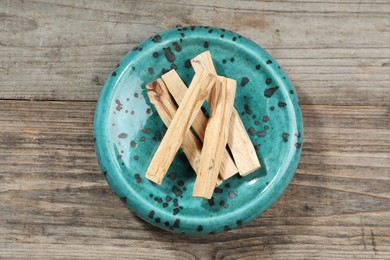 Photo of Palo santo sticks on wooden table, top view