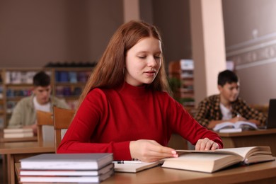 Photo of Girl studying at desk in public library