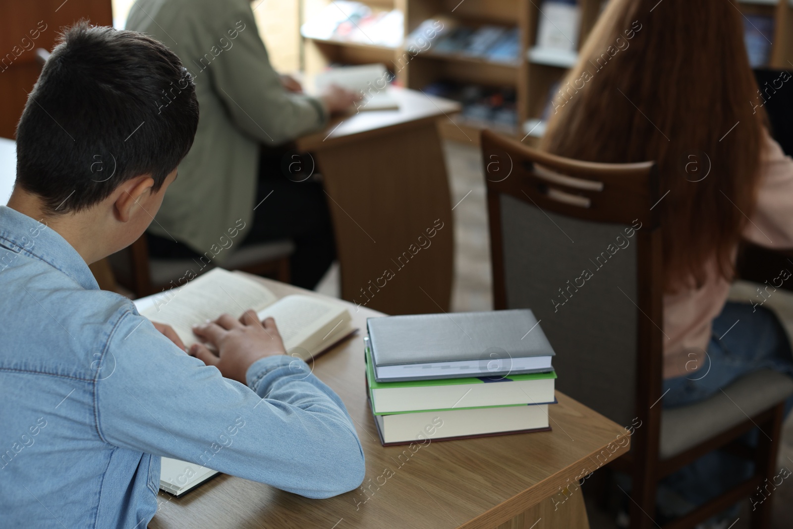 Photo of Students studying at desks in public library