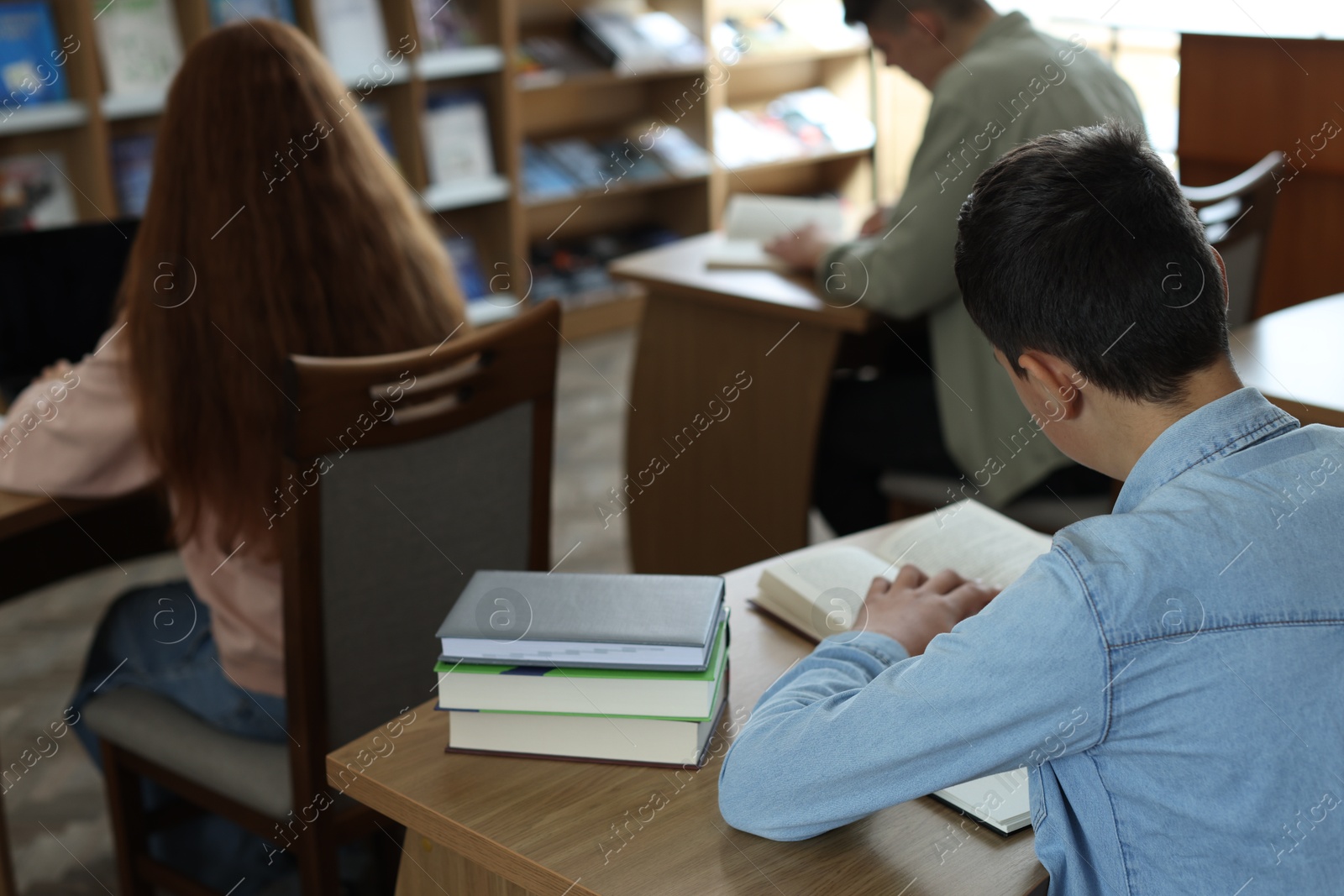 Photo of Students studying at desks in public library