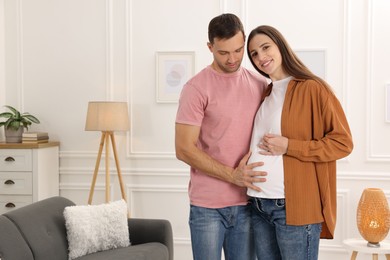 Photo of Pregnant woman and her husband at home