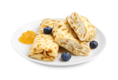 Photo of Delicious crepes with cottage cheese, jam and blueberries isolated on white