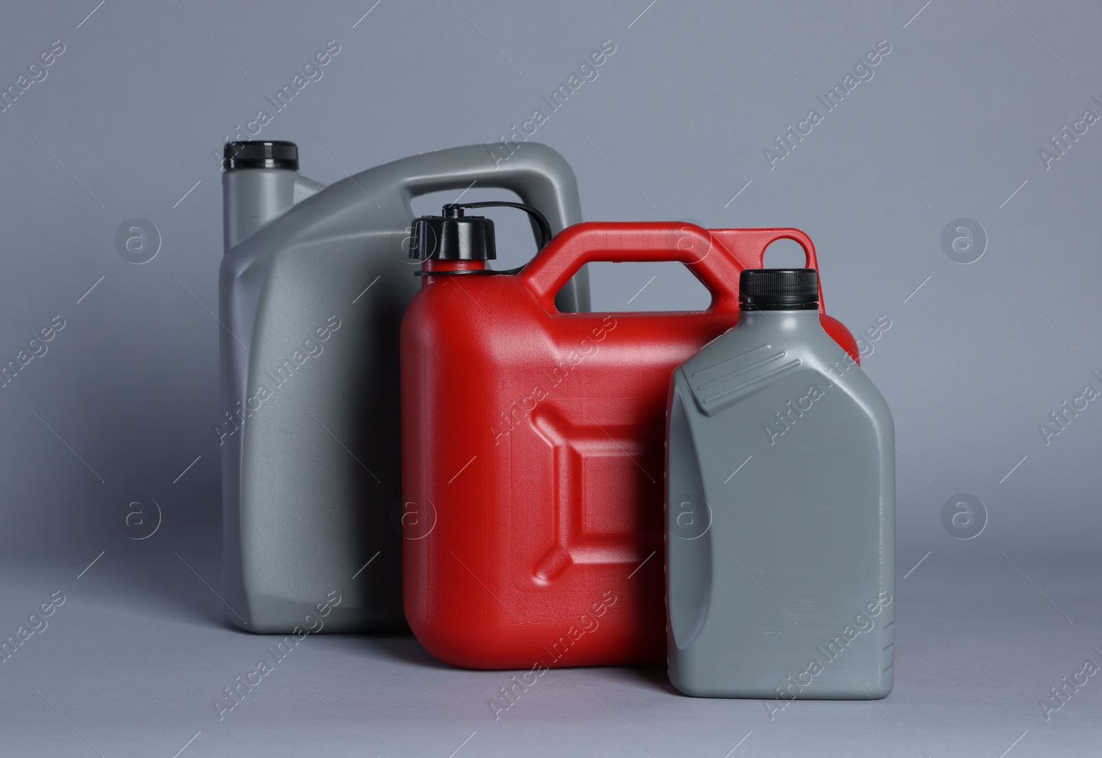 Photo of Many different plastic canisters on light grey background