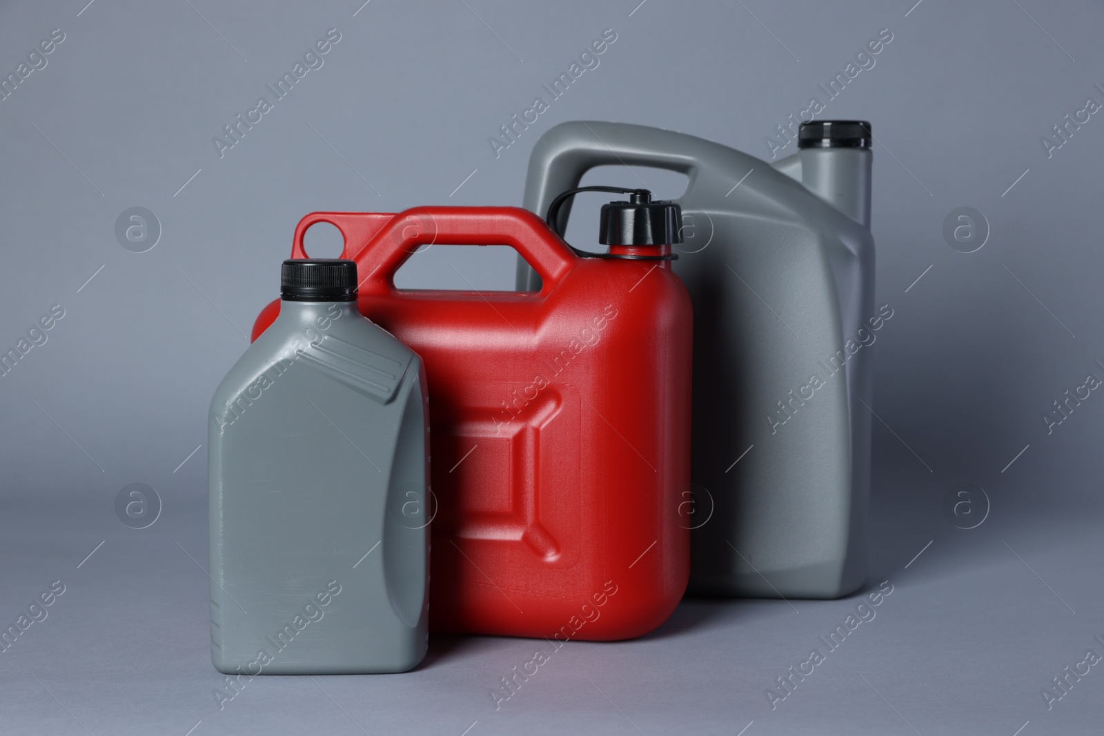 Photo of Many different plastic canisters on light grey background