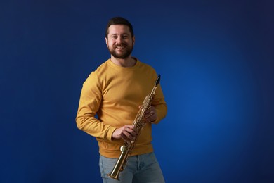 Photo of Professional musician with soprano saxophone on blue background